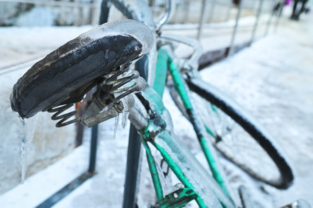 green retro bike in ice on a background of snow in winter in a severe frost.の写真素材