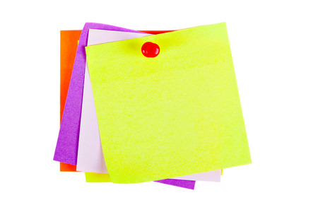 the yellow sheet for notes pierced the red pushpin closeup on white backgroundの写真素材