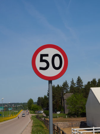 Traffic sign speed limit 50 kilometers per hour on the road.の写真素材