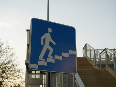 Pedestrian crossing sign with stairs and stairs in the background.の写真素材