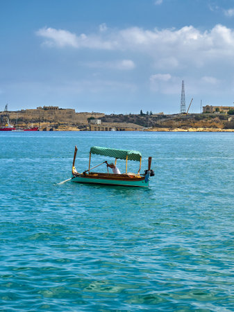 Traditional wooden boat in the middle of Marsaxlokk, Maltaの写真素材