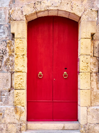 Red wooden door in the old town of Mdina, Maltaの写真素材