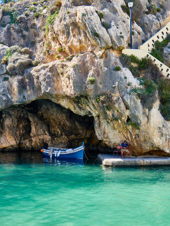 Fishing boat in turquoise water of the Mediterranean sea, Gozo, Malta
