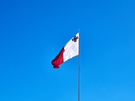 Flag of the Republic of Malta on a background of blue sky.の写真素材