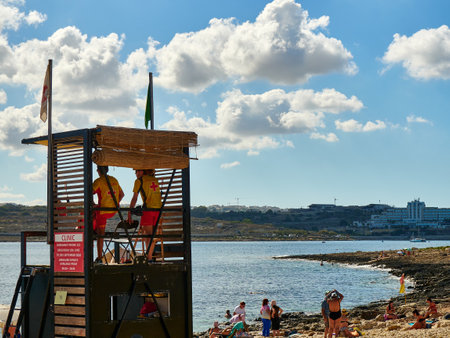 Lifeguard tower on the beach, people relax on the beach in Maltaの写真素材