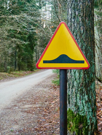Traffic sign on a country road in the middle of the forest