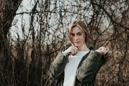 Beautiful young european woman with blonde hair, wide eyebrows and blue eyes looking at camera. Girl...