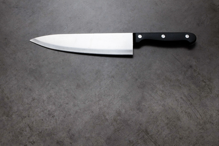 Chef knife on a dark gray table