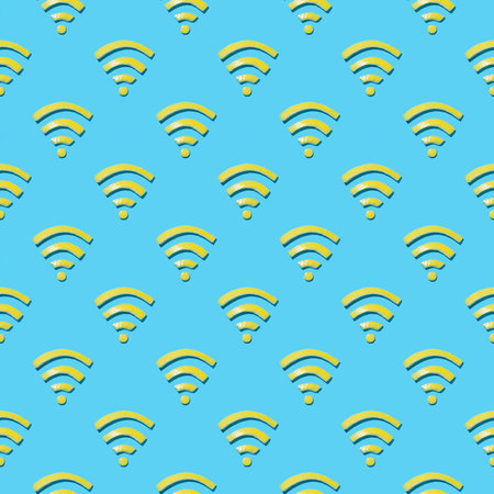 Wireless internet symbol concept created from cut lemon peels shaped into WiFi symbol and arranged into pattern on bright blue background. Minimal idea, flat lay.の写真素材