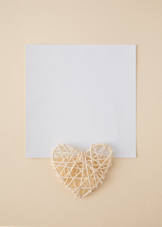 Tan color holiday greeting card with space for text and heart shape decorationの写真素材