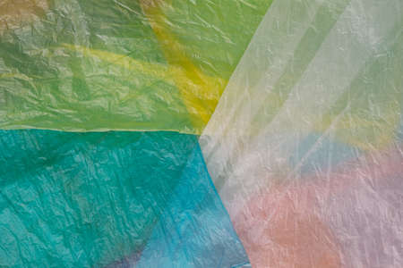 Yellow, white and blue plastic shopping bags layered in beautiful eco waste minimal concept.