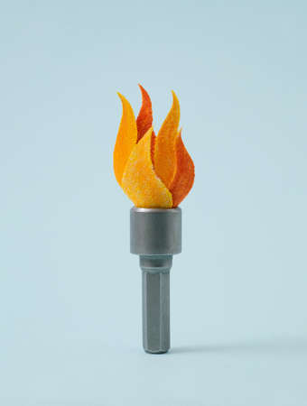 Fire torch symbol made from hex nut tool on blue background for simple Olympics sports concept