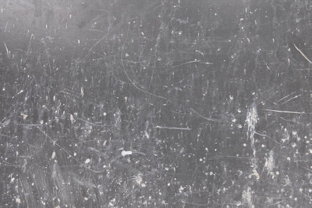 Dirty scratched gray wall with white paint splotches. Artsy background.の写真素材