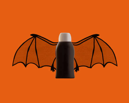Hygiene plastic bottle mockup with black bat wings. Halloween concept.の写真素材