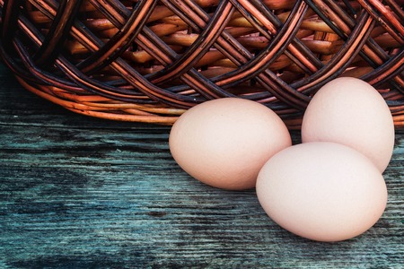 egg and basket on a wooden background