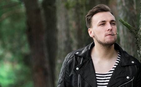 The guy in the leather jacket in the woodsの写真素材