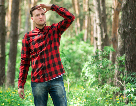 Trendy guy in a pine forestの写真素材