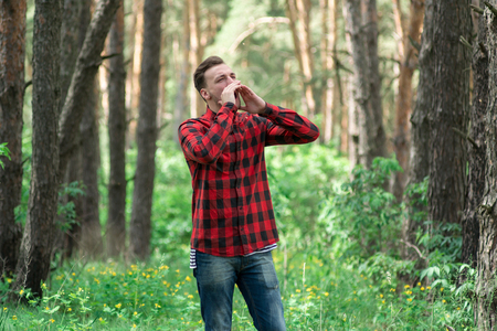 Man lost in the woods and calling for helpの写真素材