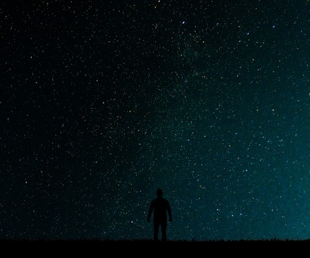 Silhouette of man on a background of stars..Man desires guess looking at the stars.の写真素材