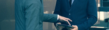 Two businessman with tablet. Presentation tablet. Business meeting companies.Photos can be used for...