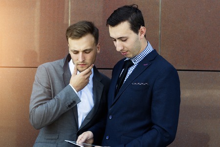 Two businessman with tablet. Presentation tablet. Business meeting companies.の写真素材