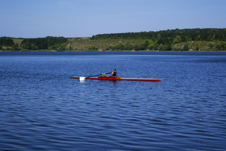 Man in red canoe floating down the river.の写真素材