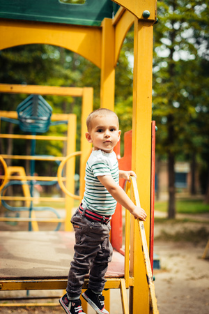 Little boy is a bright playground. Joyful child Summer holidays.の写真素材