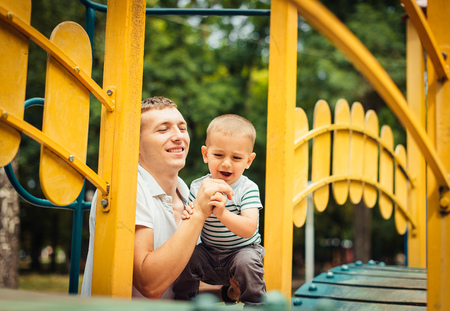 young father and little son on the playgroundの写真素材