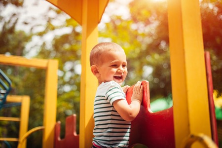 Little boy is a bright playground. Joyful child Summer holidays.の写真素材