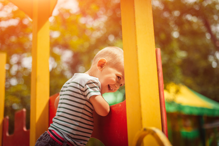 Little boy is a bright playground. Joyful child Summer holidays.の写真素材