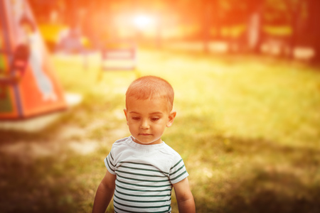 Little boy is a bright playground. Joyful child Summer holidays.の写真素材