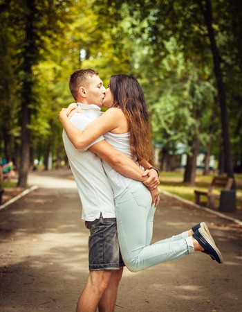 Loving couple in the park. The guy hugs a girlの写真素材