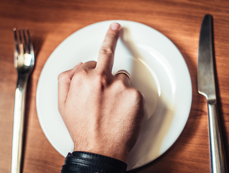 Man in shirt is showing fuck off with the middle fingerの写真素材