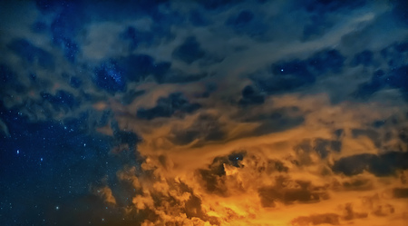 Clouds in the night sky. Starry night Red sky at night. There is noise on the photo.の写真素材