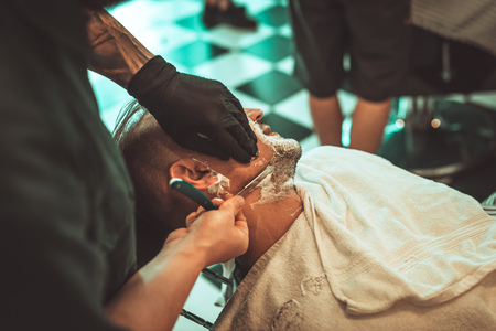 Haircut men BarberShop. Mens Hairdressers barbers. Barber cuts the client razor for haircuts.の写真素材