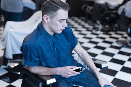 Barber on the chair. Barber expects the client to sit in the chair.の写真素材