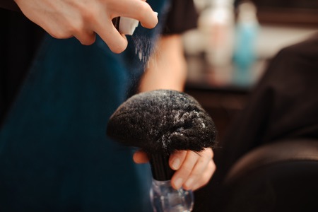 Barber speaks hoarsely talcum powder on the brush.の写真素材