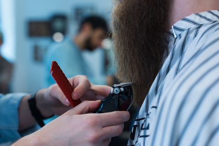 Barbershop. Close-up of a man's haircut, master Barber Shop does the hair stylingの写真素材