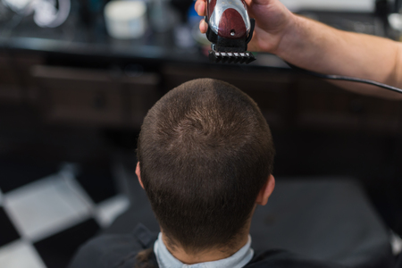 Man having a haircut with a hair clippersの写真素材