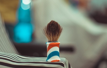Shaving brush on the blurred background. Shave in barbershop.の写真素材