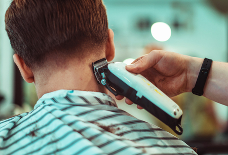 Concept fashion and beauty, man s haircut with trimmer In beauty salon. Focus on the hair.の写真素材