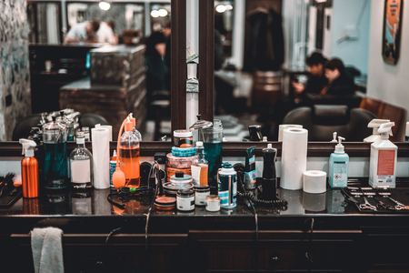 Workplace of the hairdresser. Wax hair, clay hair and a variety of Barber tools.の写真素材