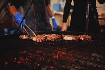 steaks cooking over flaming grill. Street food.の写真素材