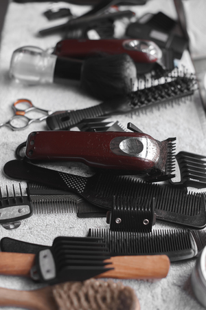 Barber tools on a white towel. Scissors, a razor, and other hairdressing tools.の写真素材