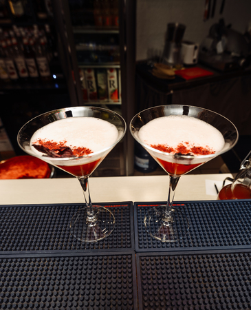 Ready red cocktail in a glass at the bar.の写真素材