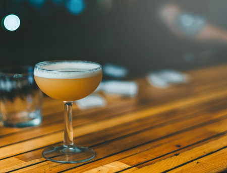 Ready for a yellow cocktail on a wooden backgroundの写真素材