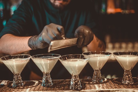 Pouring milk cocktail. Great plan. Bartender and cocktailの写真素材