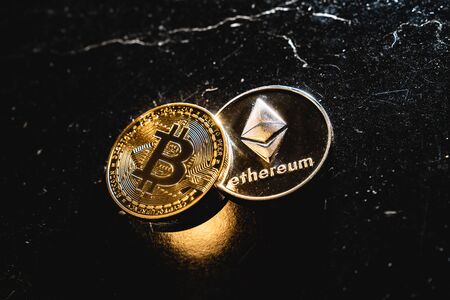 Bitcoin on a dark background. Ethereum and bitcoin rise and fall in price.の写真素材
