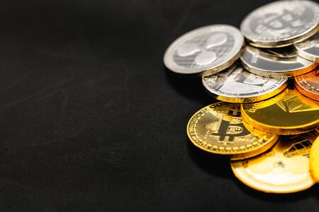 Bitcoin on a dark background. Many cryptocurrency coins on black background.の写真素材