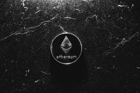 Bitcoin on a dark background. Ethereum and bitcoin rise and fall in price.の写真素材